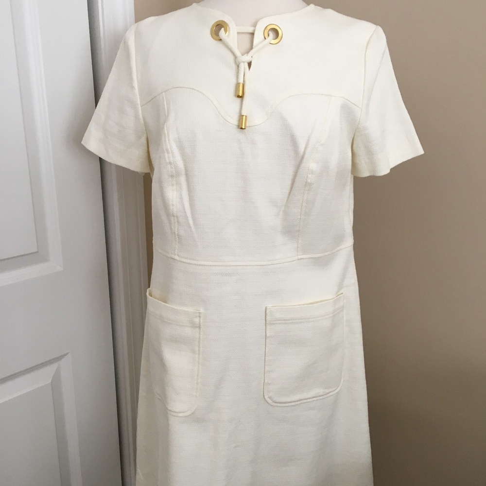 White lined dress with chunky gold accent